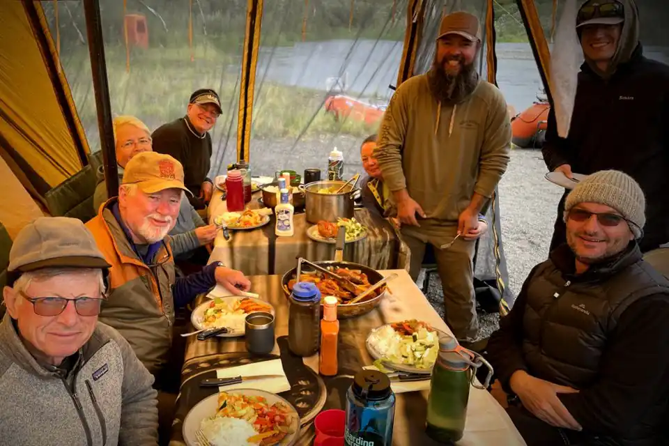 Group gatherd for dinner on the Goodnews River