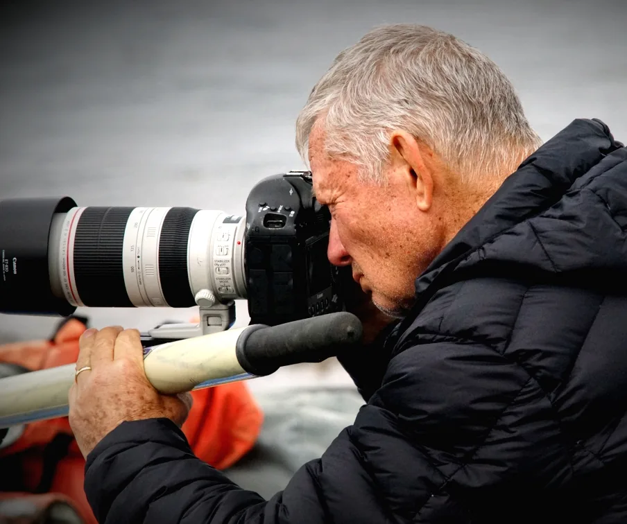 Photographer using a telephoto lens in bear habitat
